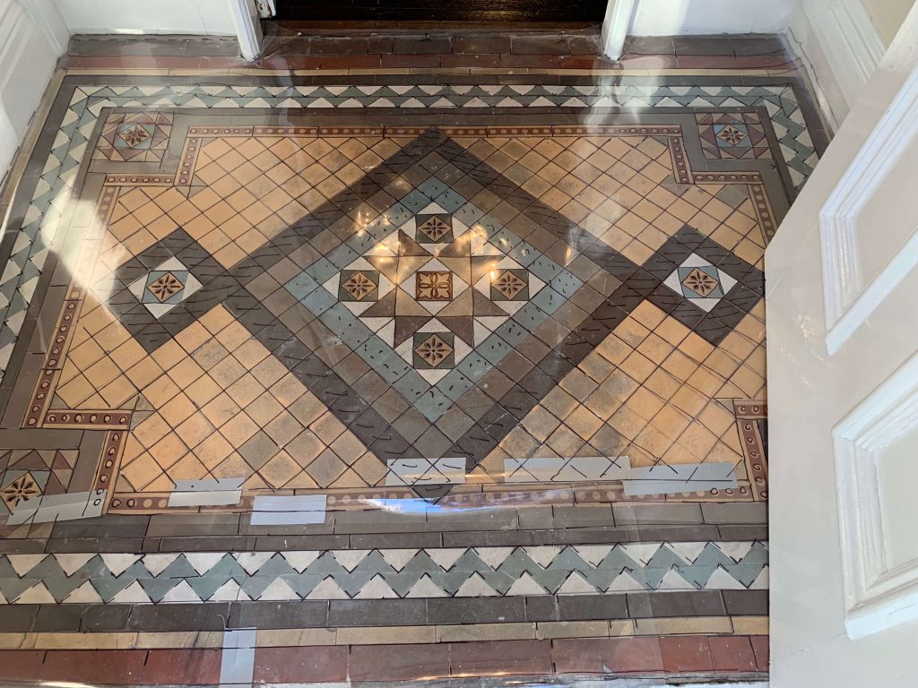 Lovely geometric and encaustic tiled entrance porch which sadly had numerous loose and damaged tiles, uneven and door sticking. We traced, carefully lifted, transported back to our workshop, reconstructed and installed.